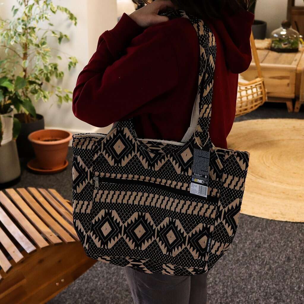Patterned canvas tote bag with tribal geometric design, perfect for everyday use.