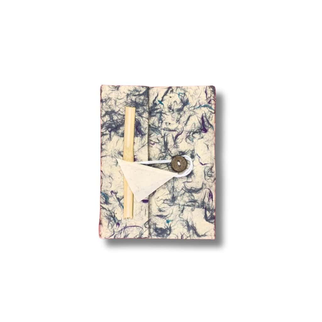 Handmade paper travel kit with wooden stick and sewing needle, stylish for travel and organisation.